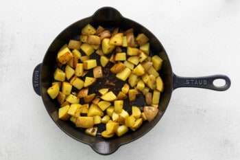 cooked diced potatoes in a cast iron skillet.