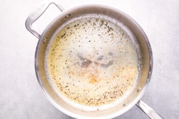 melted butter and ground black pepper in a stainless steel pan.