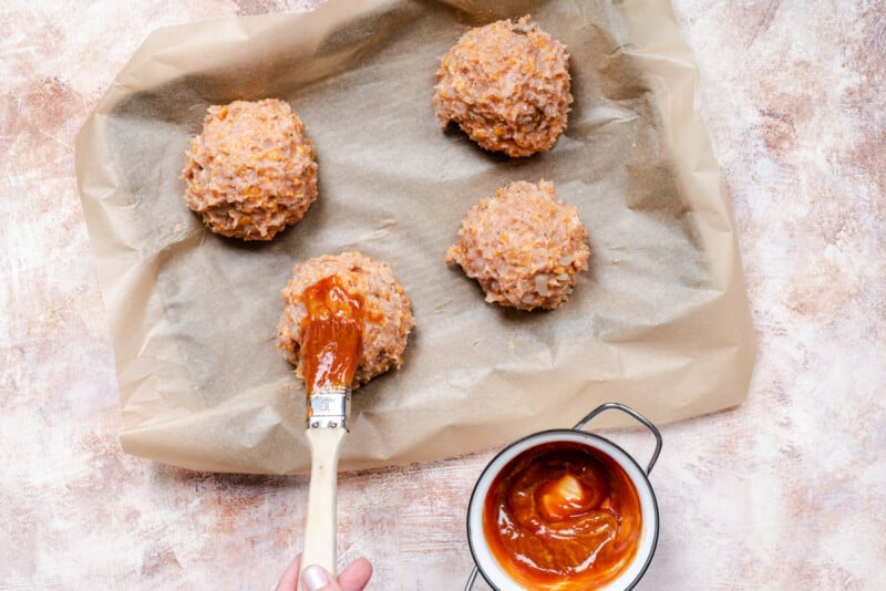 balls of meatloaf on a baking tray, unbaked