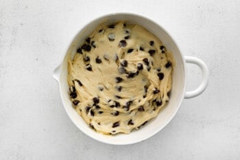chocolate chips added to cake mix chocolate chip cookie dough in a white bowl.