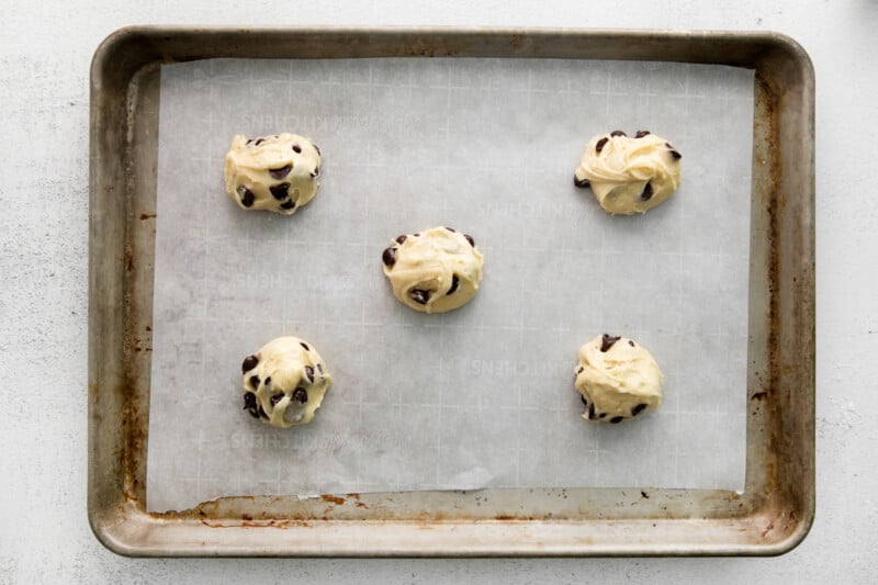 5 cake mix chocolate chip cookie dough balls on a baking sheet.