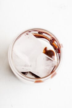 chocolate syrup and iced cubes in a glass