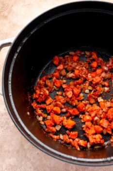 diced carrots, onions, and garlic cooking in a pot