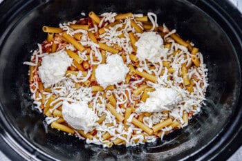 marinara, ziti, and dollops of ricotta in a crockpot.