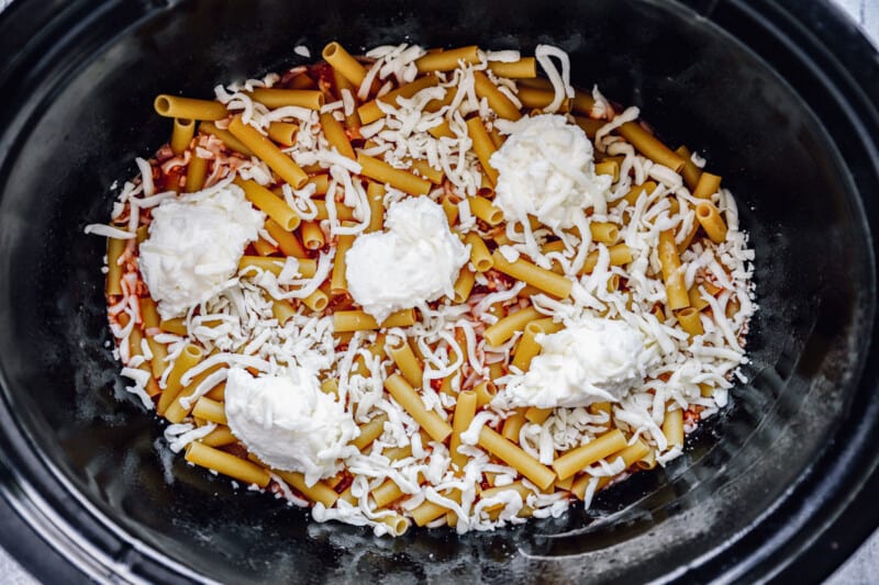 marinara, ziti, and dollops of ricotta in a crockpot.