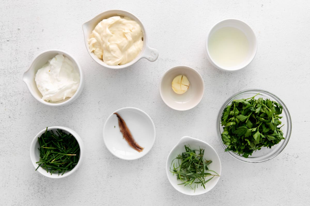 Ingredients for green goddess dressing arranged in small bowls. - 6