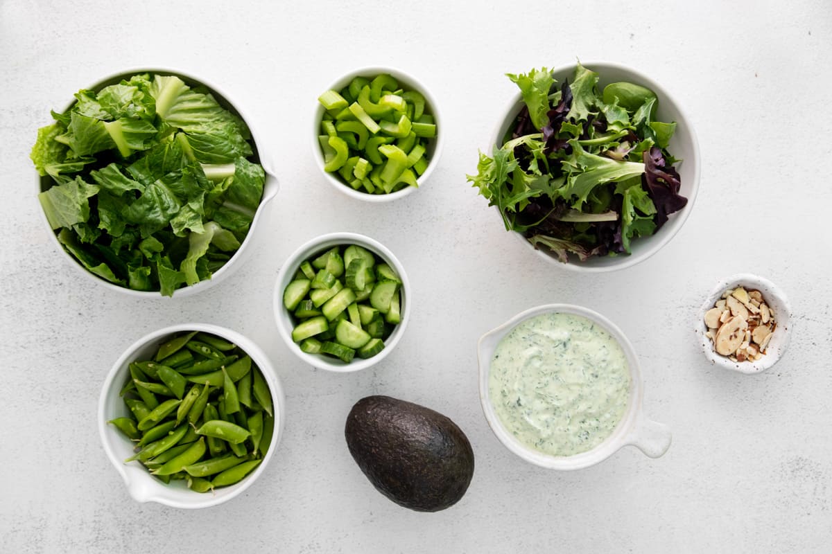Ingredients for a green goddess salad arranged in bowls - 10