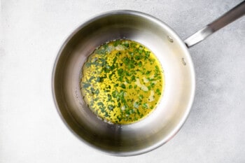 melted ghee, garlic, and cilantro in a pot