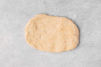 a piece of homemade naan bread before cooking