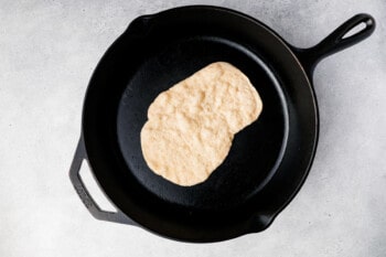 piece of naan in a cast iron skillet