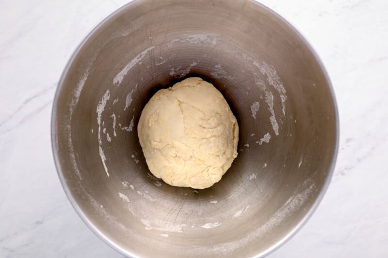 ball of pizza dough in a mixing bowl