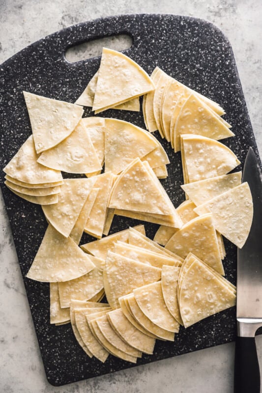 tortillas cut into wedges on a cutting board.