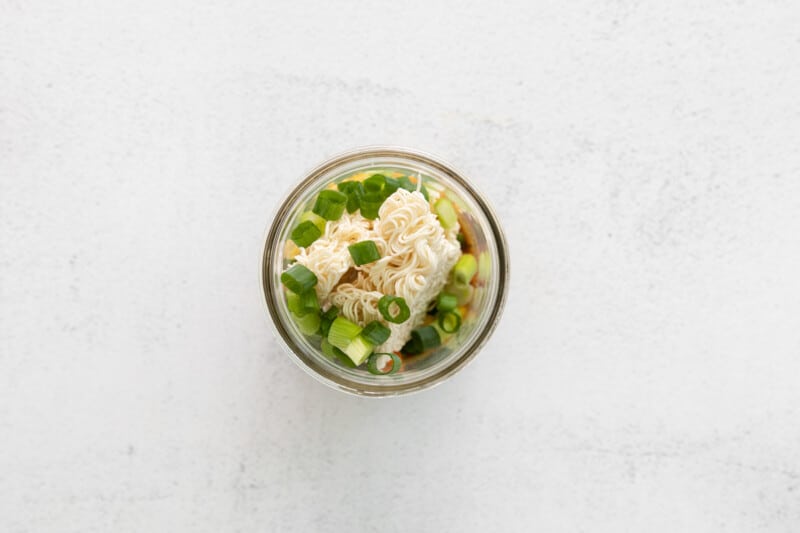 overhead view of noodles and veggies in a mason jar