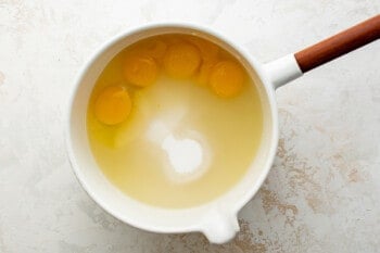 egg yolks, sugar, and other ingredients combined in a pot