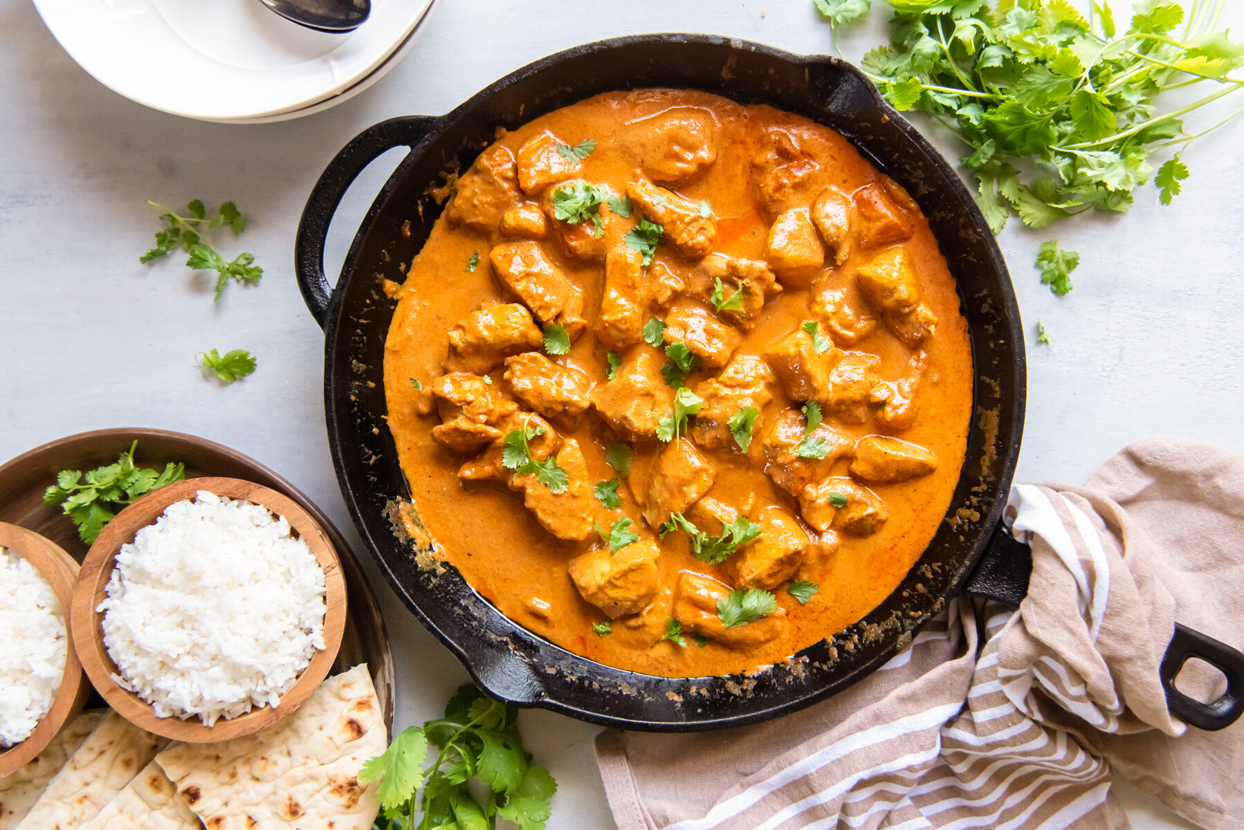 overhead view of indian butter chicken in a cast iron skillet.