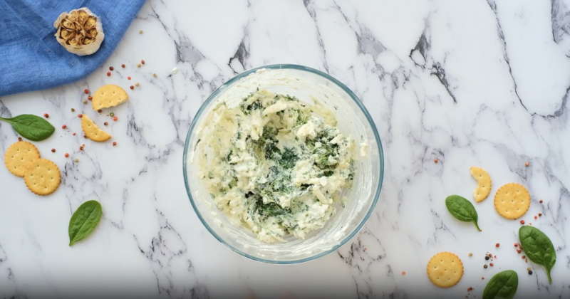 spinach dip ingredients in a glass bowl.