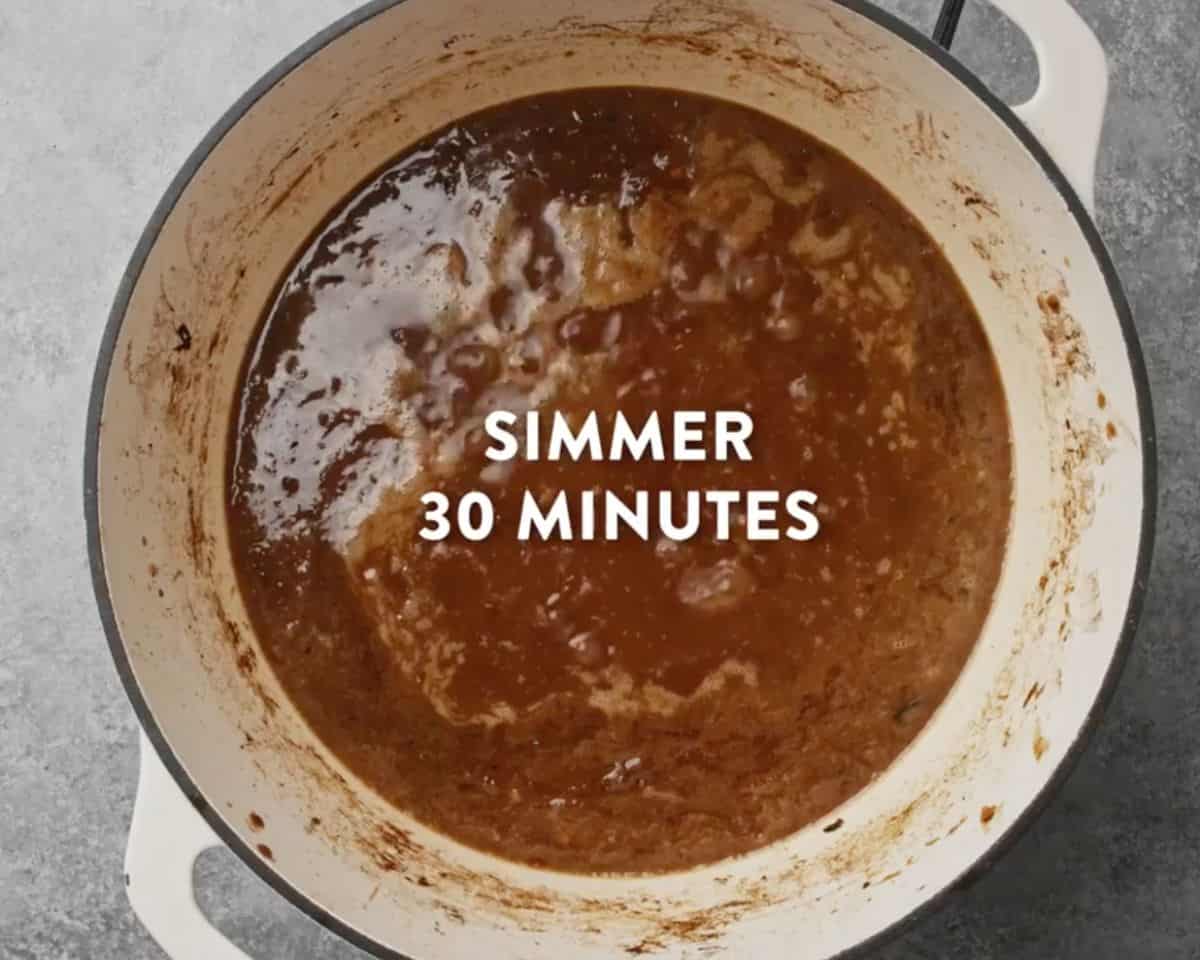 French onion soup simmering in a pot with rich brown broth