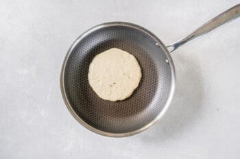 a buttermilk pancake cooking in a skillet.