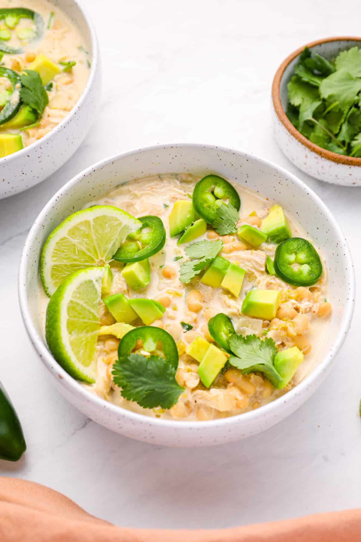 Instant pot white chicken chili in a white bowl. - 10