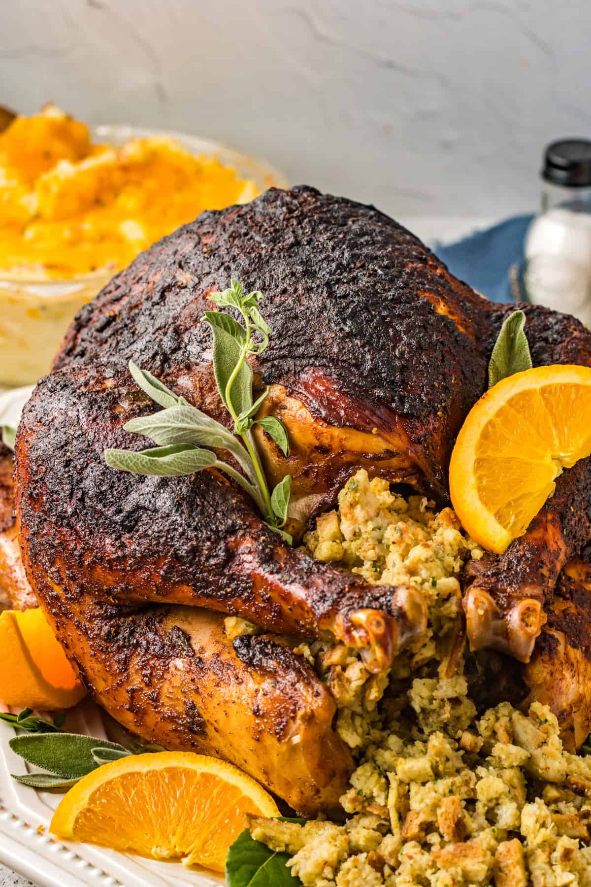 dry brined turkey with stuffing orange slices and herbs.