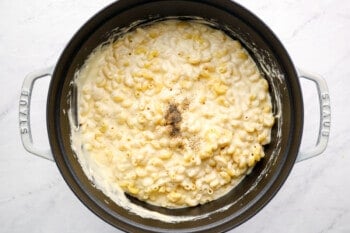 mac and cheese casserole in a white dutch oven.