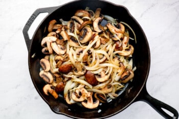 onions and mushrooms caramelizing in a skillet