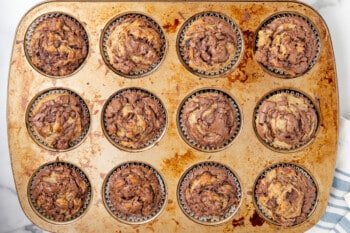 baked banana nutella muffins in a muffin tin.
