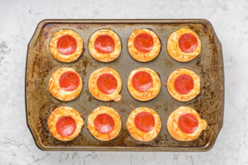 overhead view of baked pizza cupcakes in a cupcake tin.