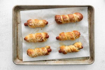 baked pretzel dogs on a baking tray