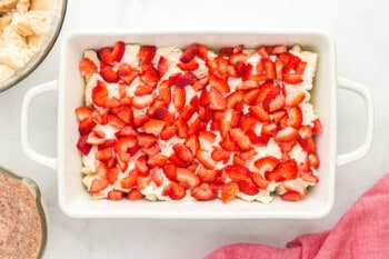 layer of sliced strawberries in a casserole dish