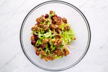 a bowl filled with greens and nuts.