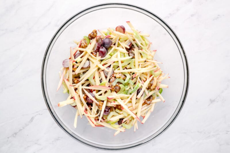 salad ingredients tossed in Waldorf salad dressing