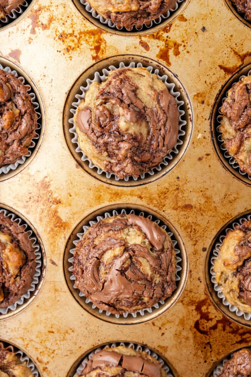 close up of nutella banana muffins in a muffin tin.