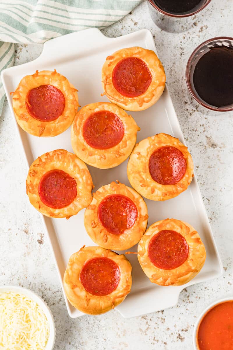 overhead view of 8 pizza cupcakes on a white serving tray.