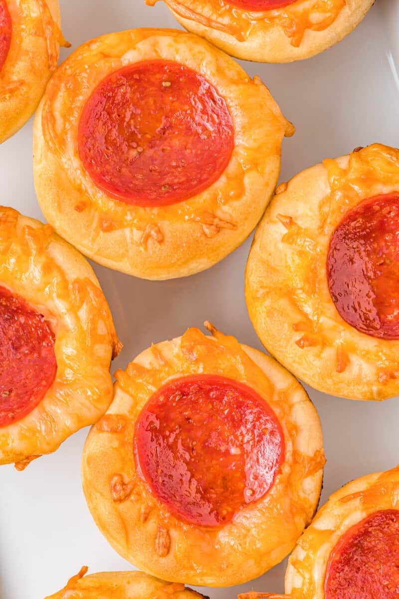 close up of pizza cupcakes on a white serving tray.