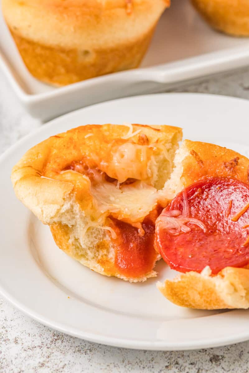 a halved pizza cupcake on a white plate.