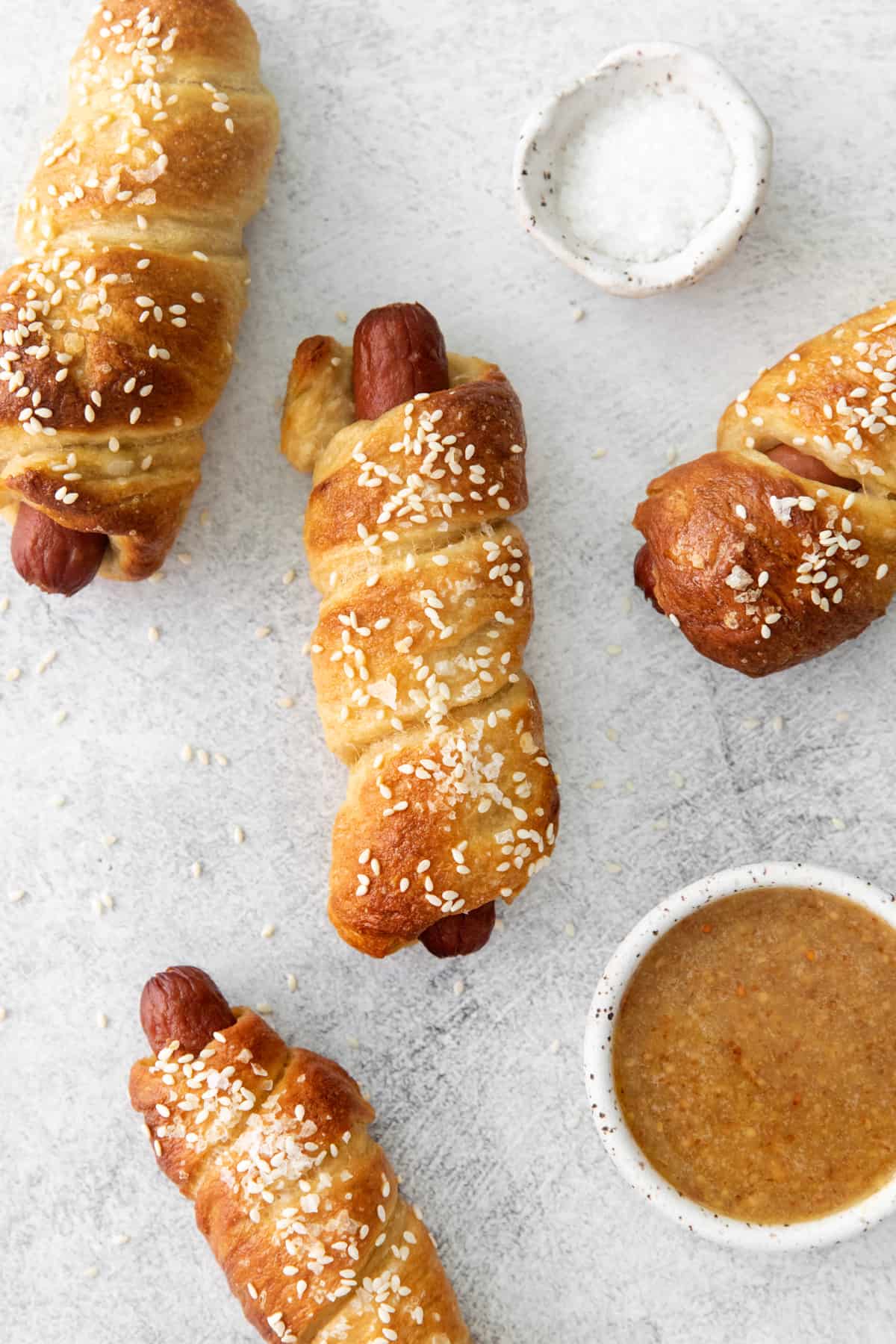 four pretzel dogs arranged on a table