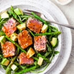 Ahi Tuna with asparagus and avocado, on speckled white dish