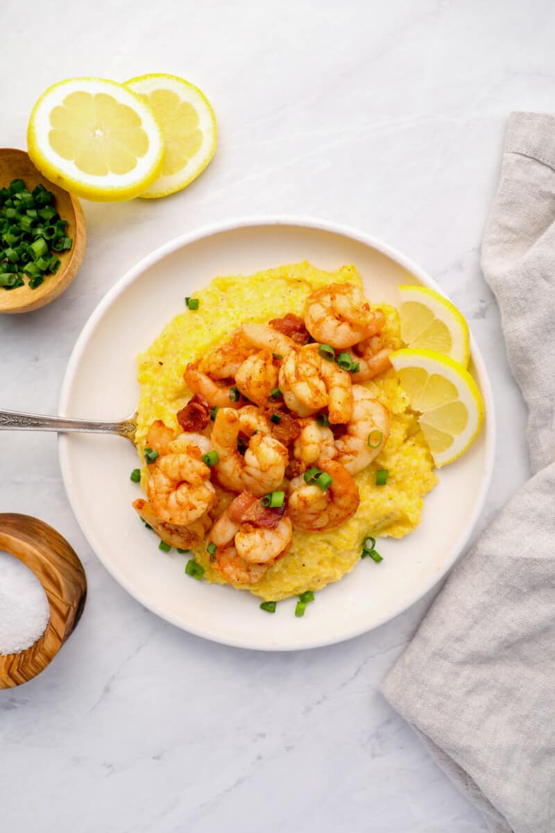 a plate of shrimp and grits on a tabletop