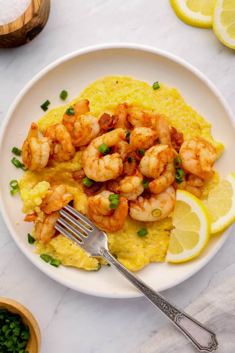 a plate of southern grits topped with cajun shrimp