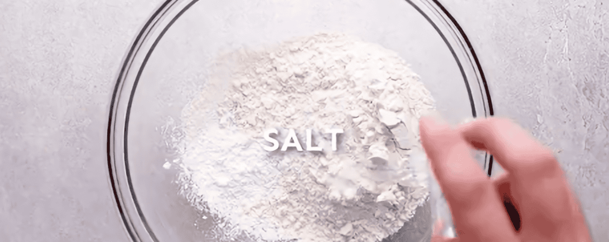 Combining dry ingredients in a bowl.