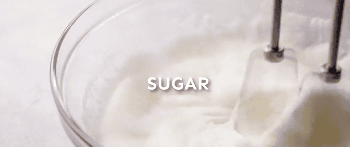 Mixing sugar with a hand held mixer.