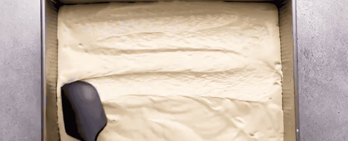 Distributing the batter into the pan.