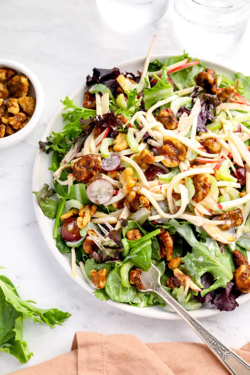 Waldorf salad filled with greens, grapes, walnuts, apples, and celery