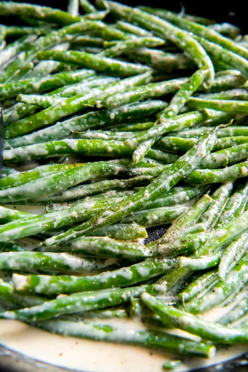 close up of creamed green beans in a serving dish.