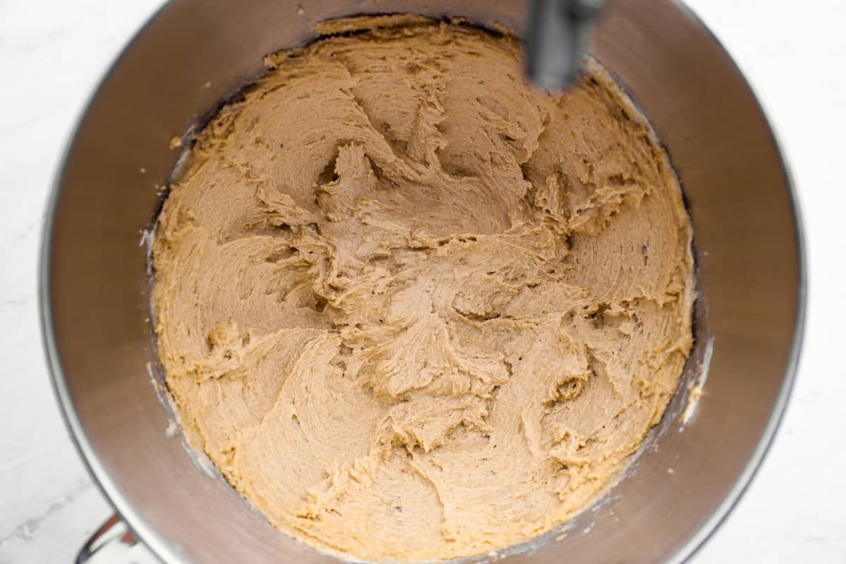 Fully mixed cookie dough, thick and scoopable with visible oats