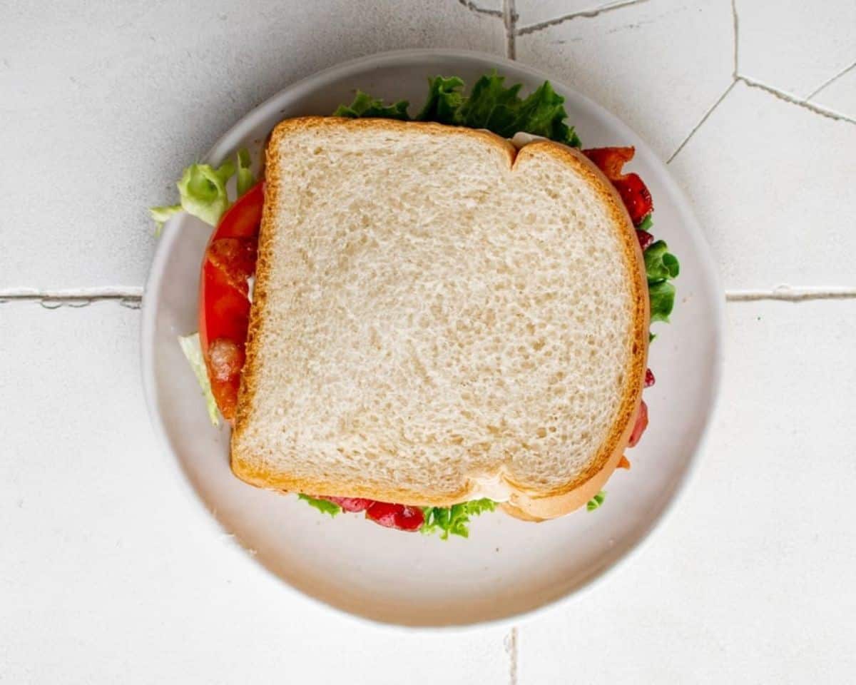 BLT sandwich on a white plate.  - 9