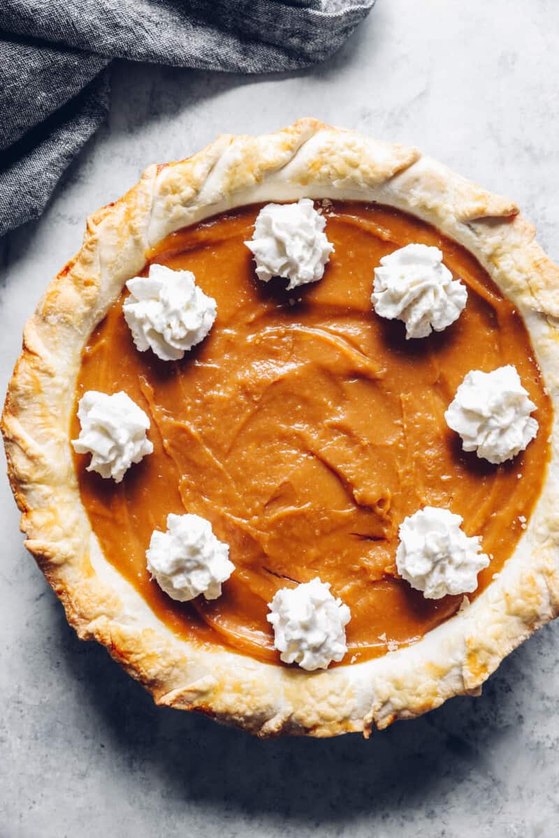 overhead view of a whole caramel pie with whipped topping