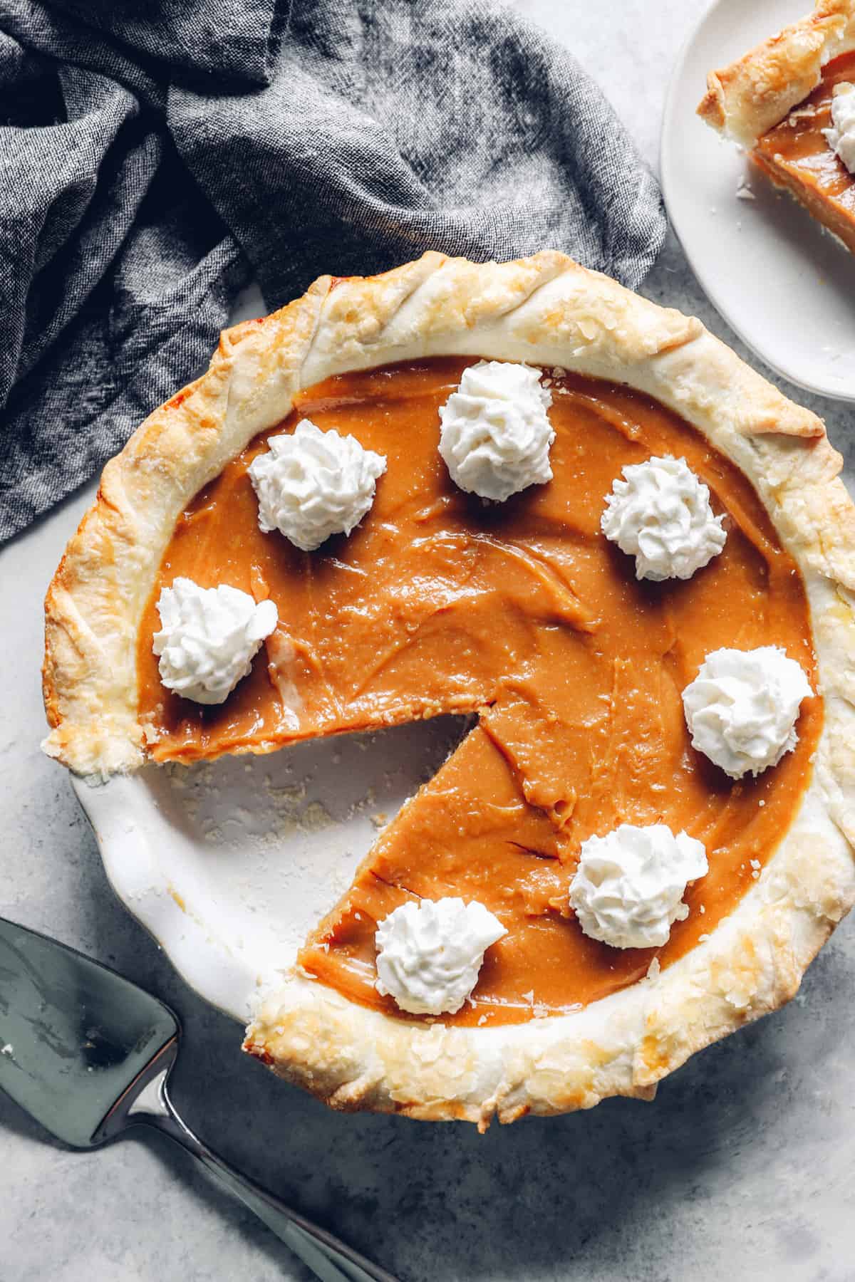 overhead view of a caramel pie with one slice removed