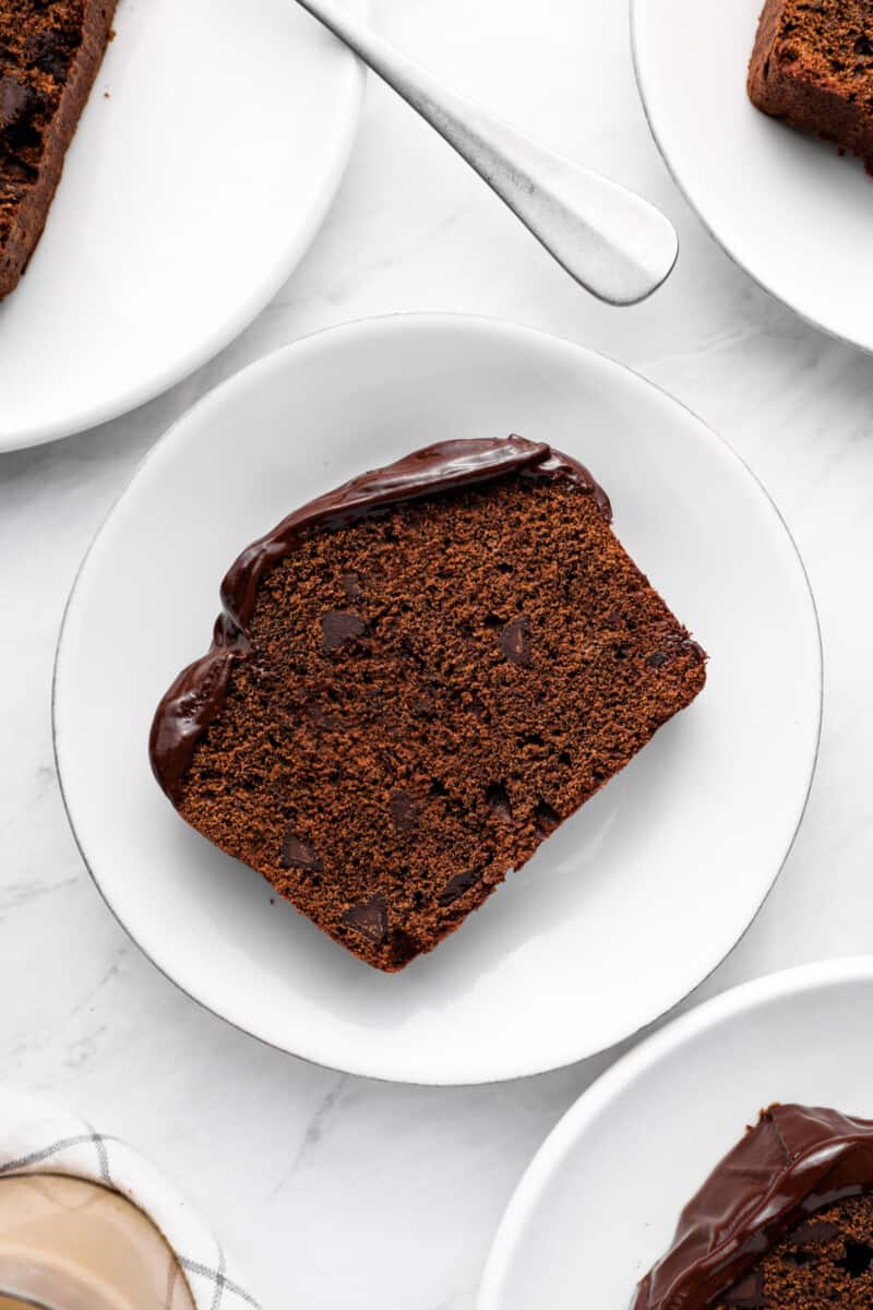 overhead view of a slice of chocolate pound cake on a white plate.